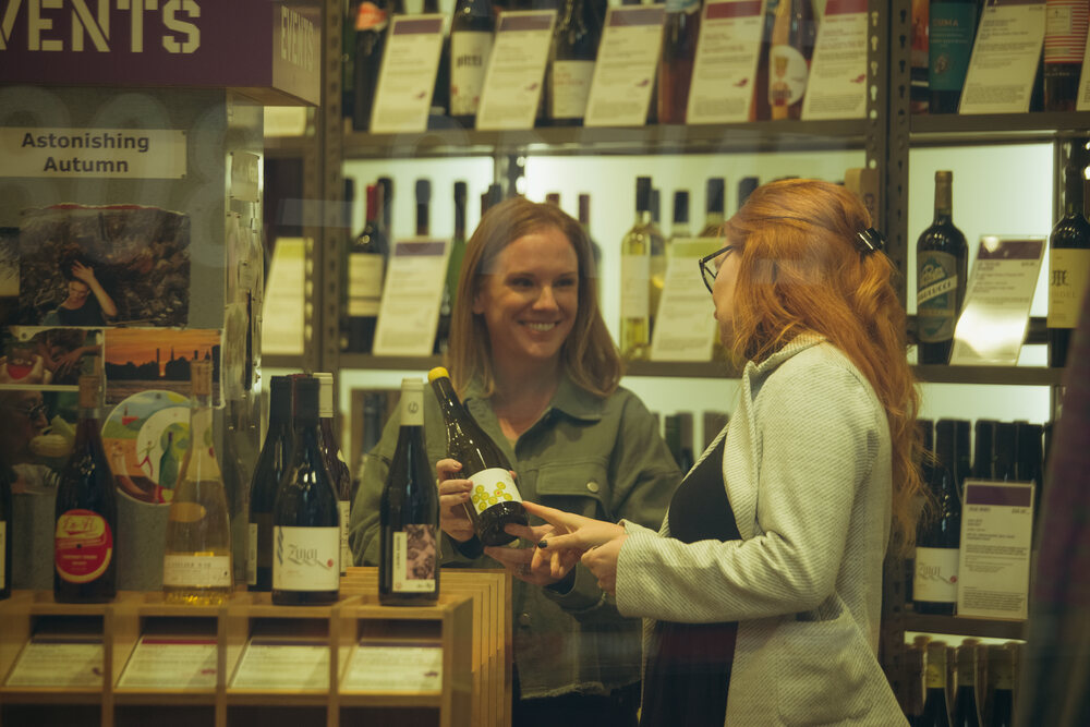 Sarah sharing a conversation in a wine shop